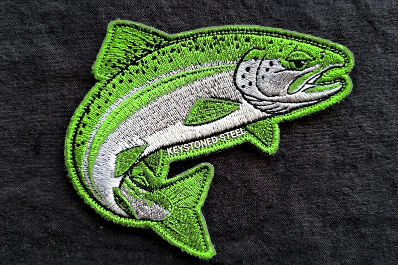 Keystoned Steel Die-Cut Fish embroidered patch — fish-shaped patch with a bright green and chrome leaping steelhead